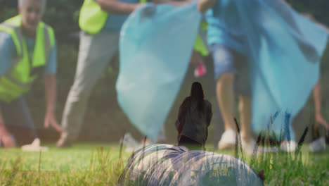 Animation-of-caucasian-couple-dancing-on-field-over-people-collecting-trash