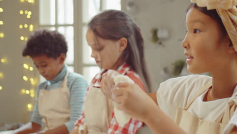 Cute-Asian-Girl-Preparing-Dough-during-Cooking-Class