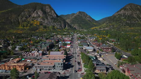 traffic main street downtown frisco colorado aerial cinematic drone early yellow fall colors aspen trees morning lake dillon keystone breckenridge silverthorne ten mile range blue sky forward motion