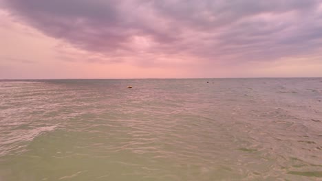 serene ocean horizon at punta cocos, holbox mexico under a dreamy pink sunset sky