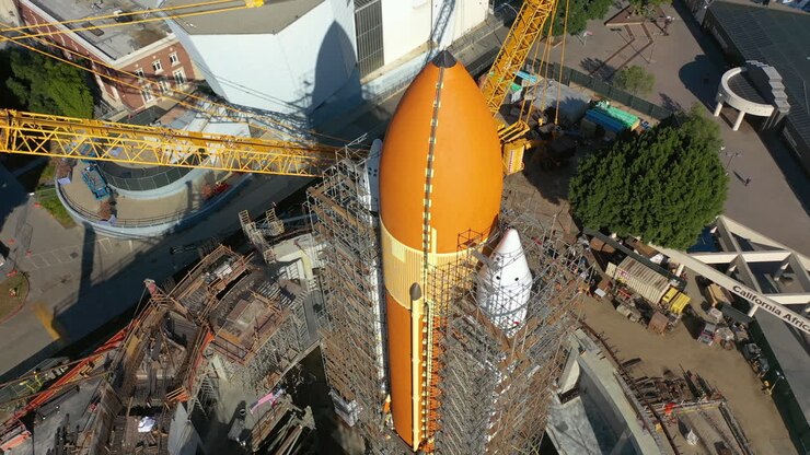 Drone shot tilting around a large space rocket, in sunny United states of America