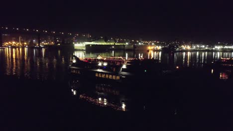 angle or movement 3 (orbit shot showing coronado bridge): night-time drone shots of a ship cruising misson bay in san diego, california. shot is 4k 60fps and can be slowed down.