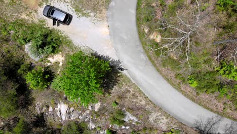 man and vehicle stranded on a country road in the middle of nowhere  drone 30fps at 4k