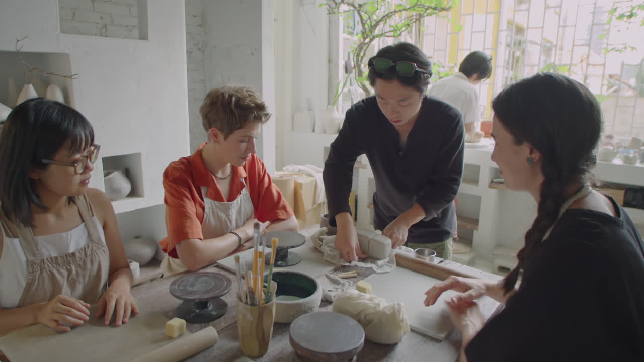 Asian Ceramist Giving Pottery Masterclass to Girls