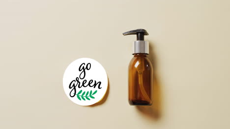 animation of go green text and leaf logo over lemon slice and beauty oil pump bottle