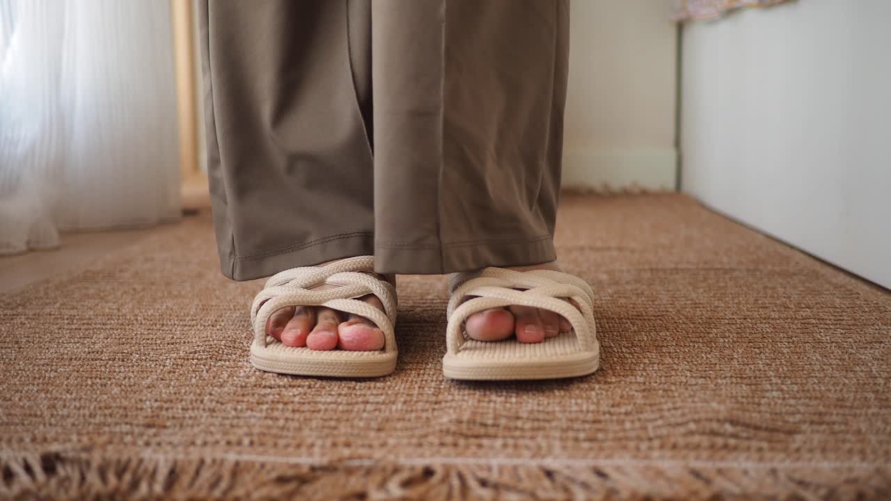 Sandals and trousers on a rug