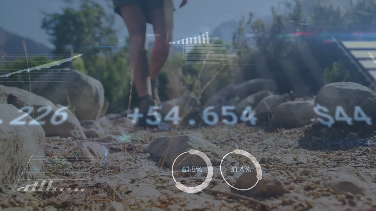 Hiker approaching camera, stepping over rocks, HUD charts and meters updating for fitness tech