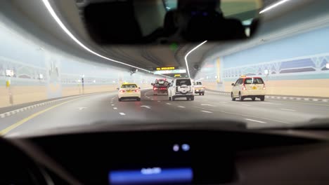 driving through a modern city tunnel at night