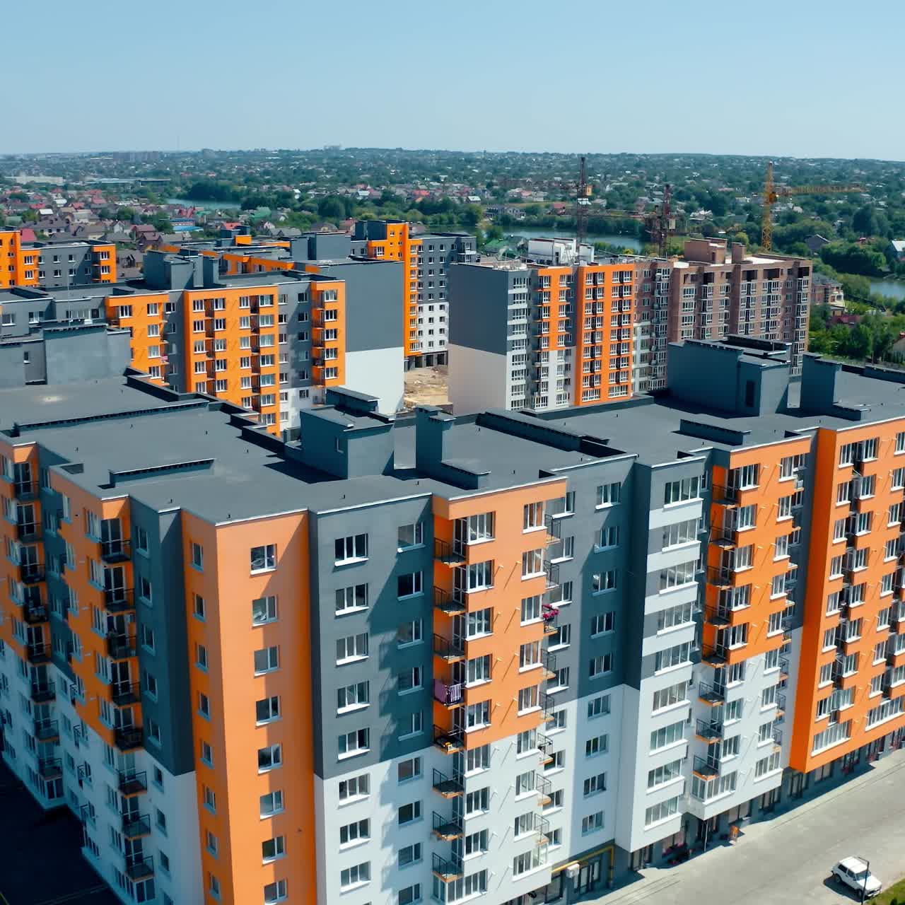 High-rise apartment buildings in the countryside. New complex of modern apartment buildings near the river. Multi-storey housing. Aerial view. Rising up