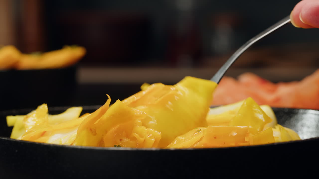 Close-up of fermented yellow cabbage on plate. Preservation of vegetables in glass jars. Fermentation preserved vegetables. Sauerkraut with spices.