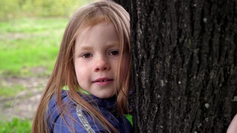 young girl hugging a tree