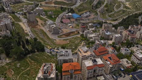 Fly-Over-Urban-Buildings-And-Roads-At-Ramallah-Town-In-The-West-Bank,-State-Of-Palestine