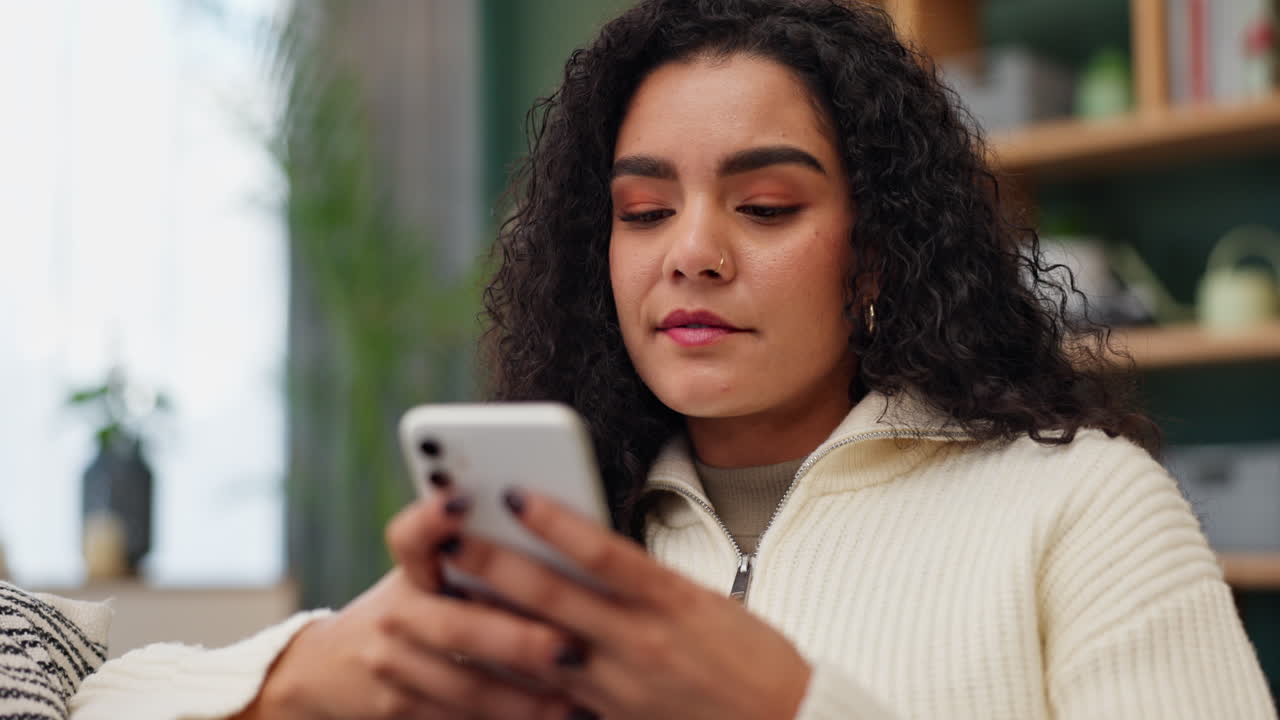 A woman looking upset while using her phone