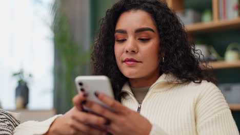 a woman looking upset while using her phone