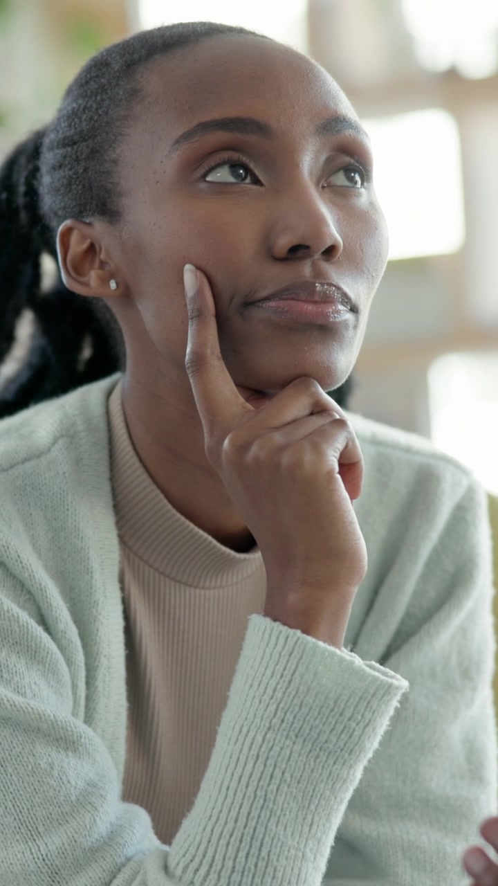 Thoughtful Young Woman Looking Up While Holding Smartphone