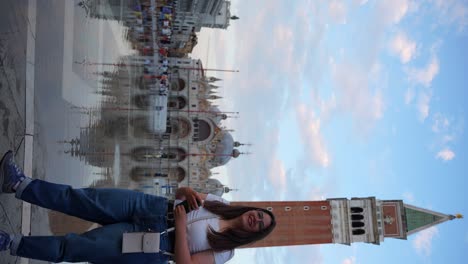 young traveler woman admires architecture of venice and turns back