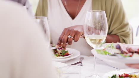 closeup of people eating food at a table