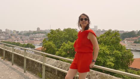 attractive female tourist looking at the views of vila nova de gaia from porto, portugal