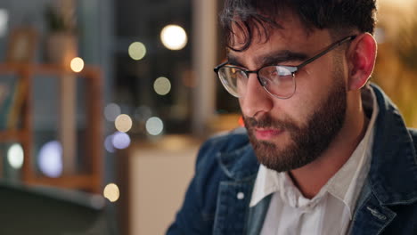 man working late at night on laptop