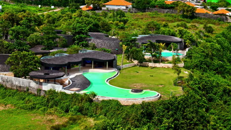 luxury cliffside villa with infinity pool in indonesia, aerial view