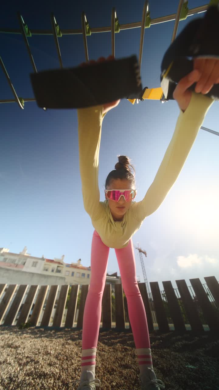 Woman exercising with resistance bands in a park