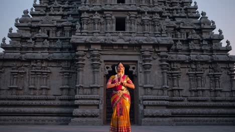 young woman, an indian classical dancer, wearing traditional dress, is performing bharatanatyam in front of a temple at dawn, showcasing indian culture and spirituality