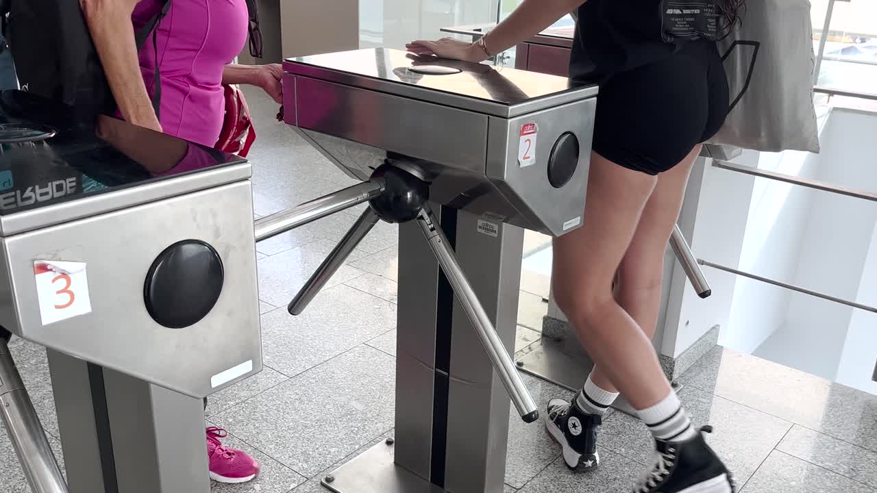 건강한 여성이 체육관에서 우아하게 나와 회전문을 통과하여 결단력과 체력을 구현합니다.