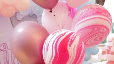 pink and white marbled balloons for a birthday party