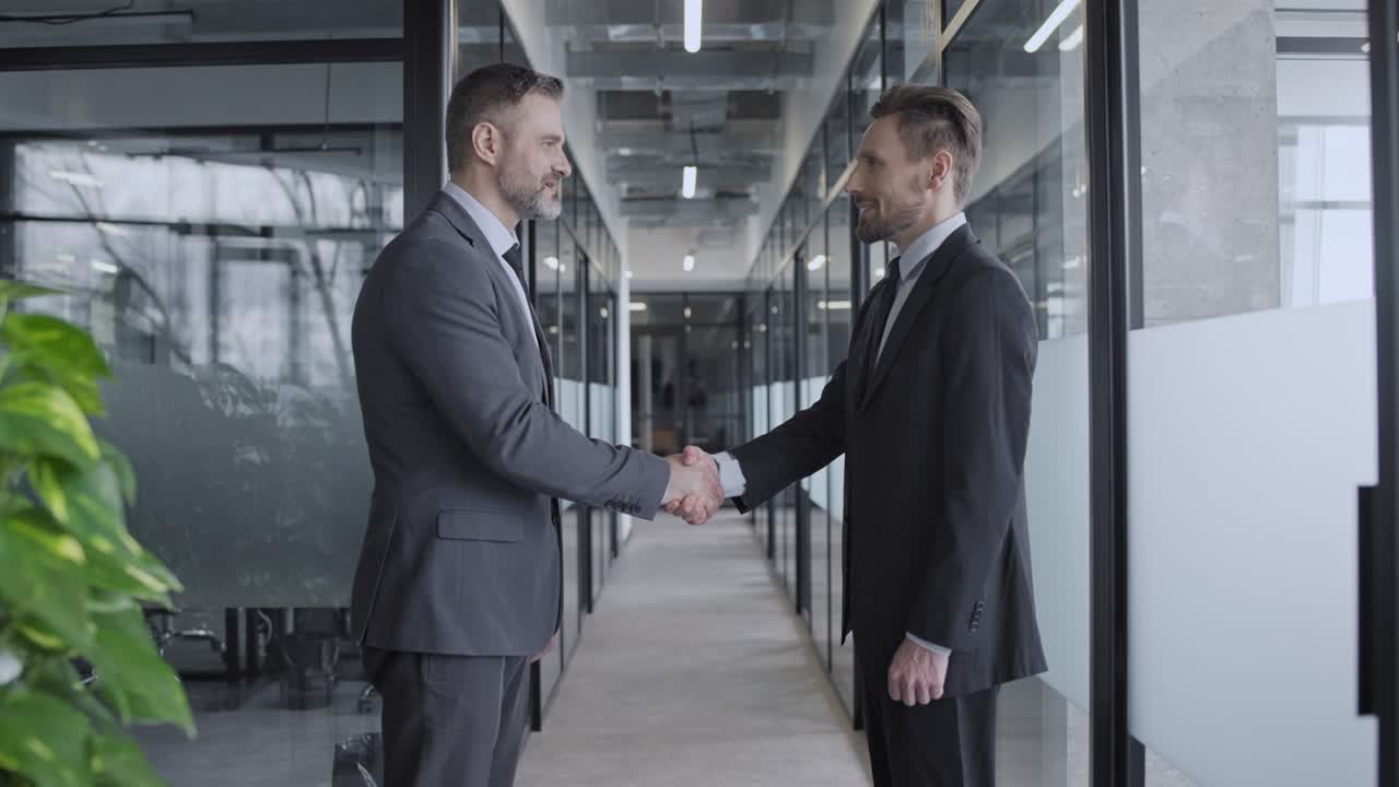 Handshake of successful male business partners in company office, cooperation