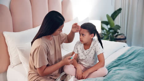 Mother,-sick-child-and-thermometer-on-bed