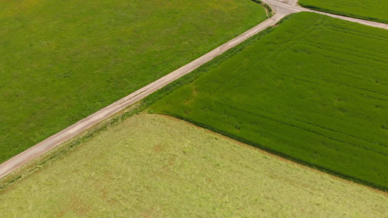 flying over rolling hills with fields in a rural countryside