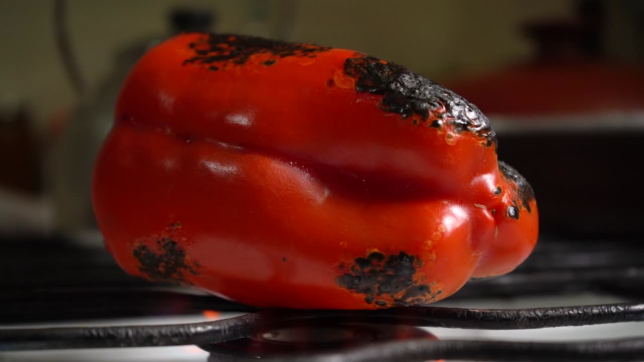 Red Bell Pepper Burning On The Stove To Remove Its Skin. close up, time lapse