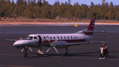 a group of passengers board a private jet