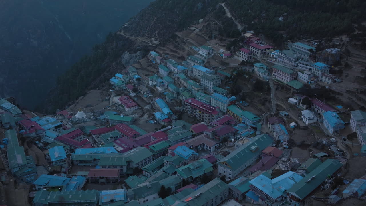 Aerial view tilting over a mountain town in middle of peaks of Sagarmatha, Nepal