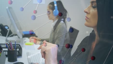Animation-of-dna-strand-over-diverse-businesswomen-using-computers