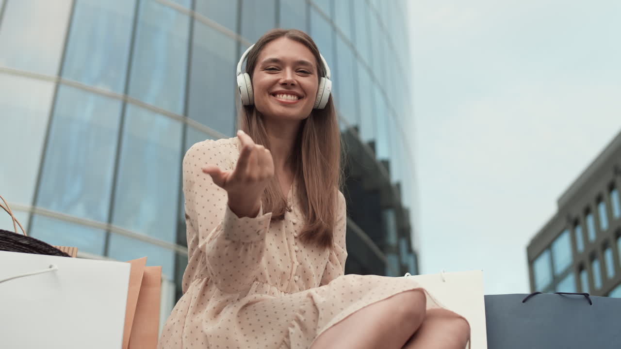 Woman Listening to Music and Beckoning