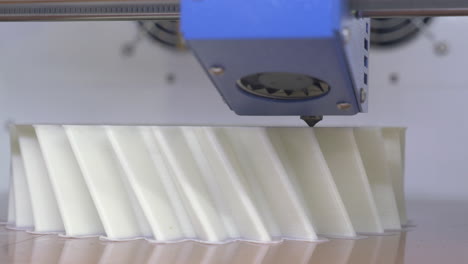 3d printing equipment making white plastic object