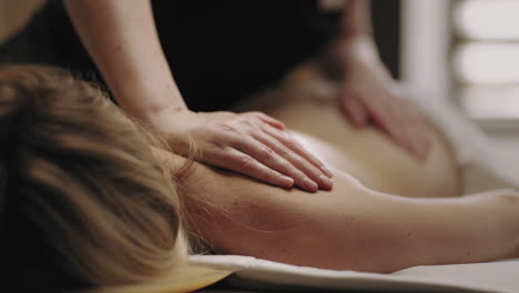 manual therapy for health spinal professional chiropractor is massaging female body in clinic