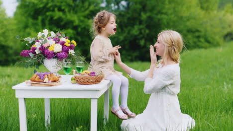 a young family is having fun in nature eating sweets and having fun