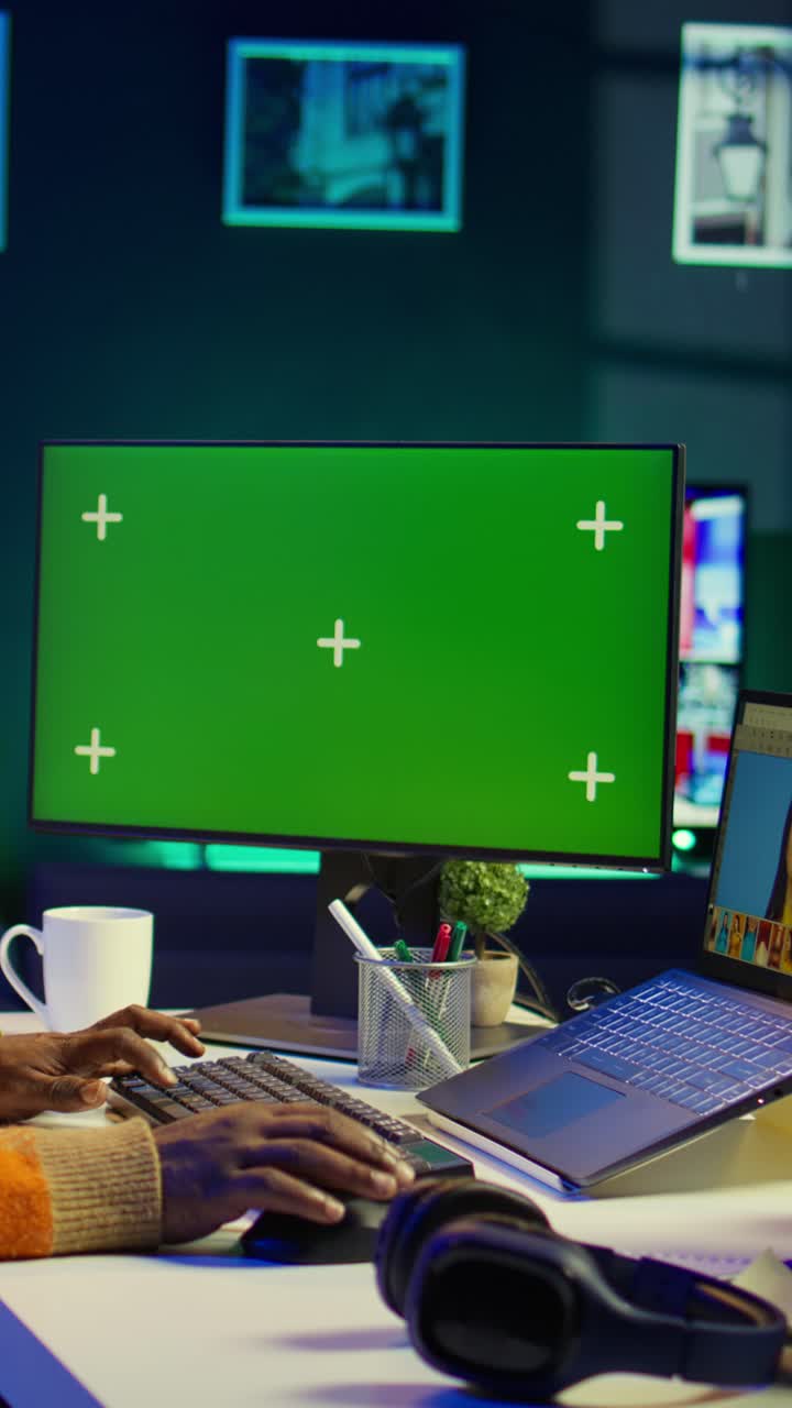 Vertical Video African american photo designer retouching images next to green screen