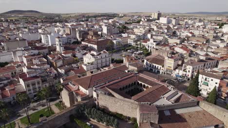 Aerial-orbit-of-muslim-heritage-fortress,-adjacent-plaza-de-espana