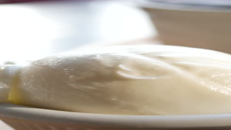 close up of a scoop of vanilla ice cream