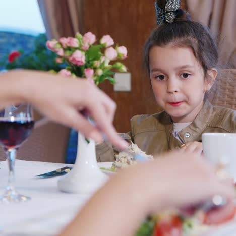 Young-Girl-Eating-in-Restaurant