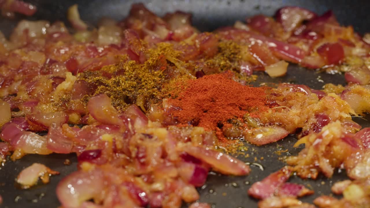 Cooking red onions with spices and paprika