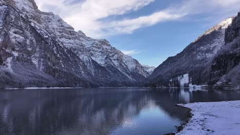 serene klöntalersee lake in klöntal, kanton glarus, switzerland, surrounded by snowy alps and winter scenery. beauty of nature, landscape.