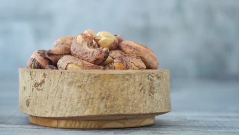 close-up of cashew nuts in a wooden bowl