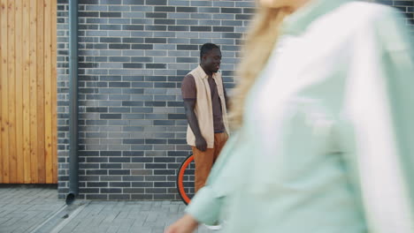 african american man and asian woman meeting and chatting on street