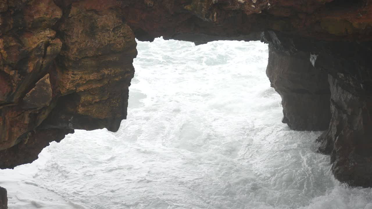 Waves Crashing Against Rocks at a Coastal Arch