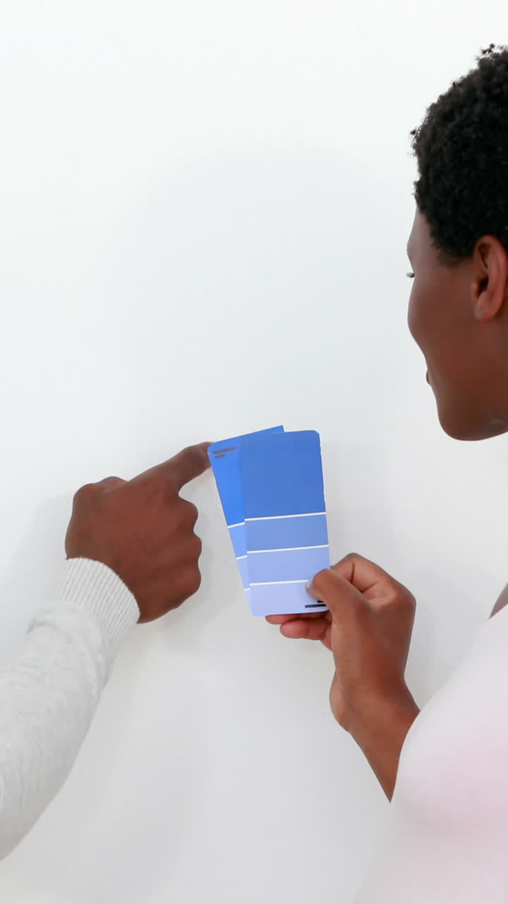 Standing couple looking at pallet of colors