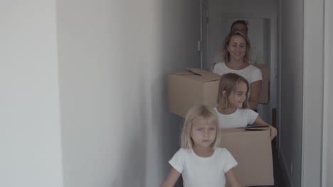 Happy-family-with-two-children-moving-into-new-apartment